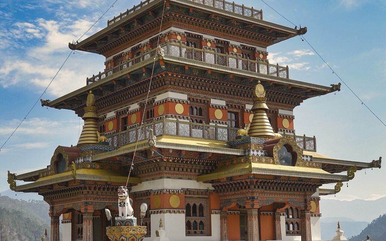 Khamsum Yulley Namgyal Chorten on its ridge above rice fields.